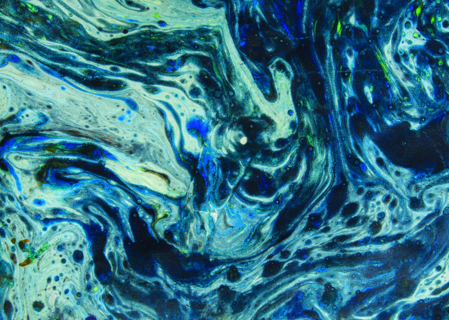 Marbling on paper using blue, green, and yellow ink