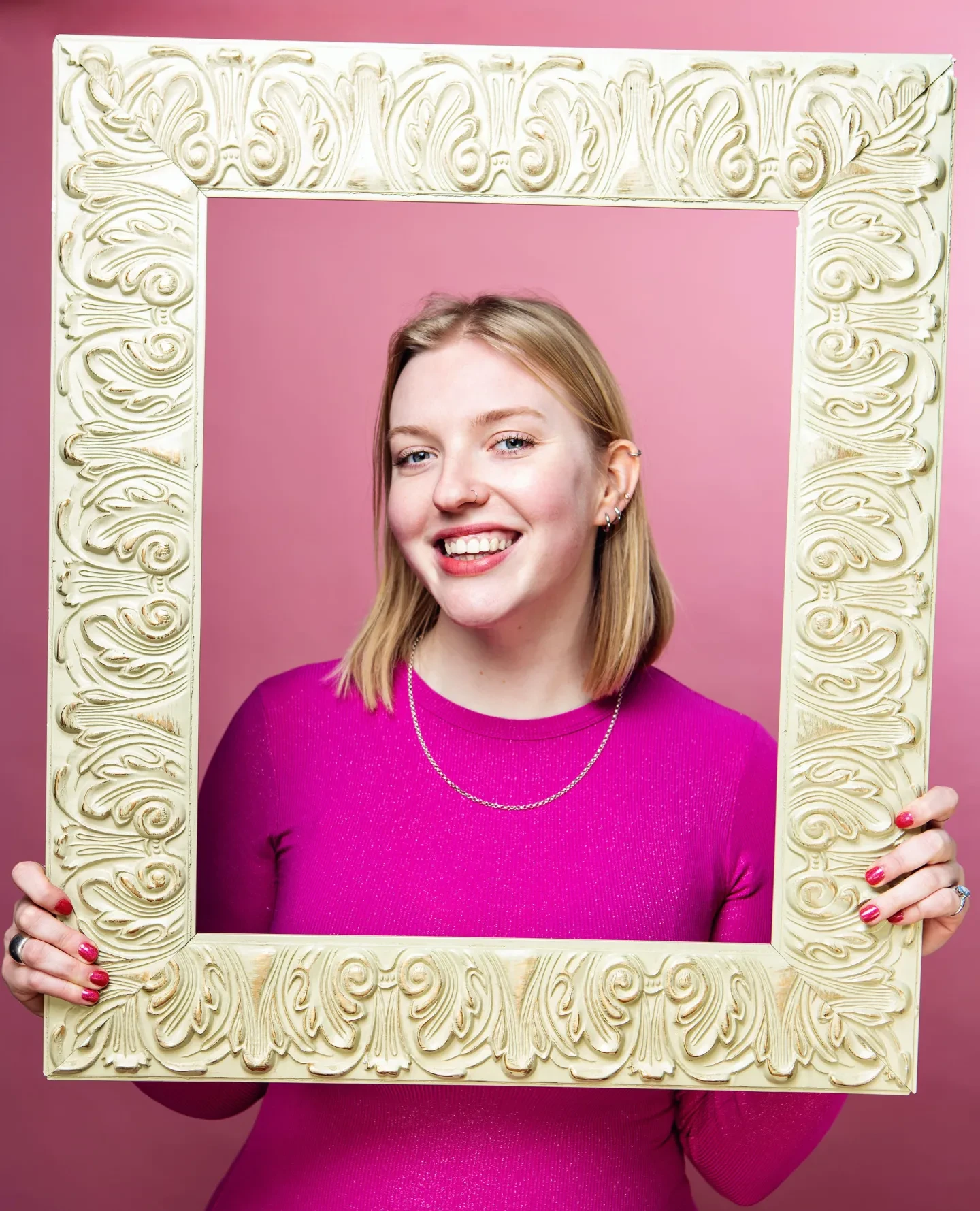 Girl holding a gold frame