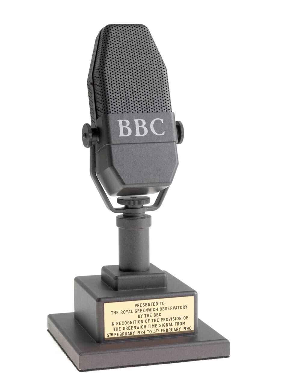 A small microphone with BBC written on it, on top of a small platform with a plaque