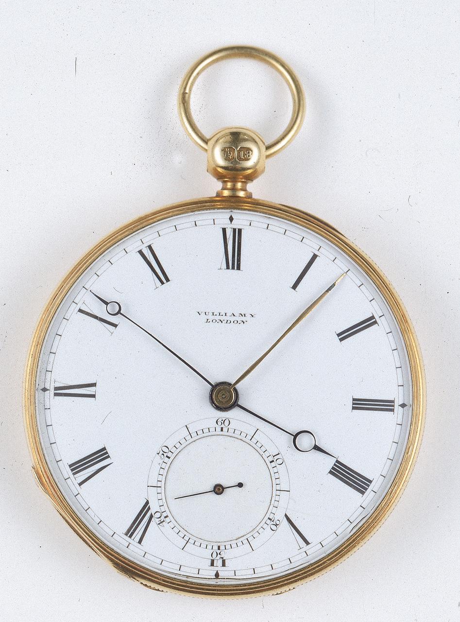 An image of a gold watch with a large face with roman numeral numbers on it, and two watch hands