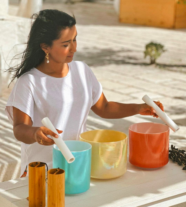 woman using crystal instruments on a beach