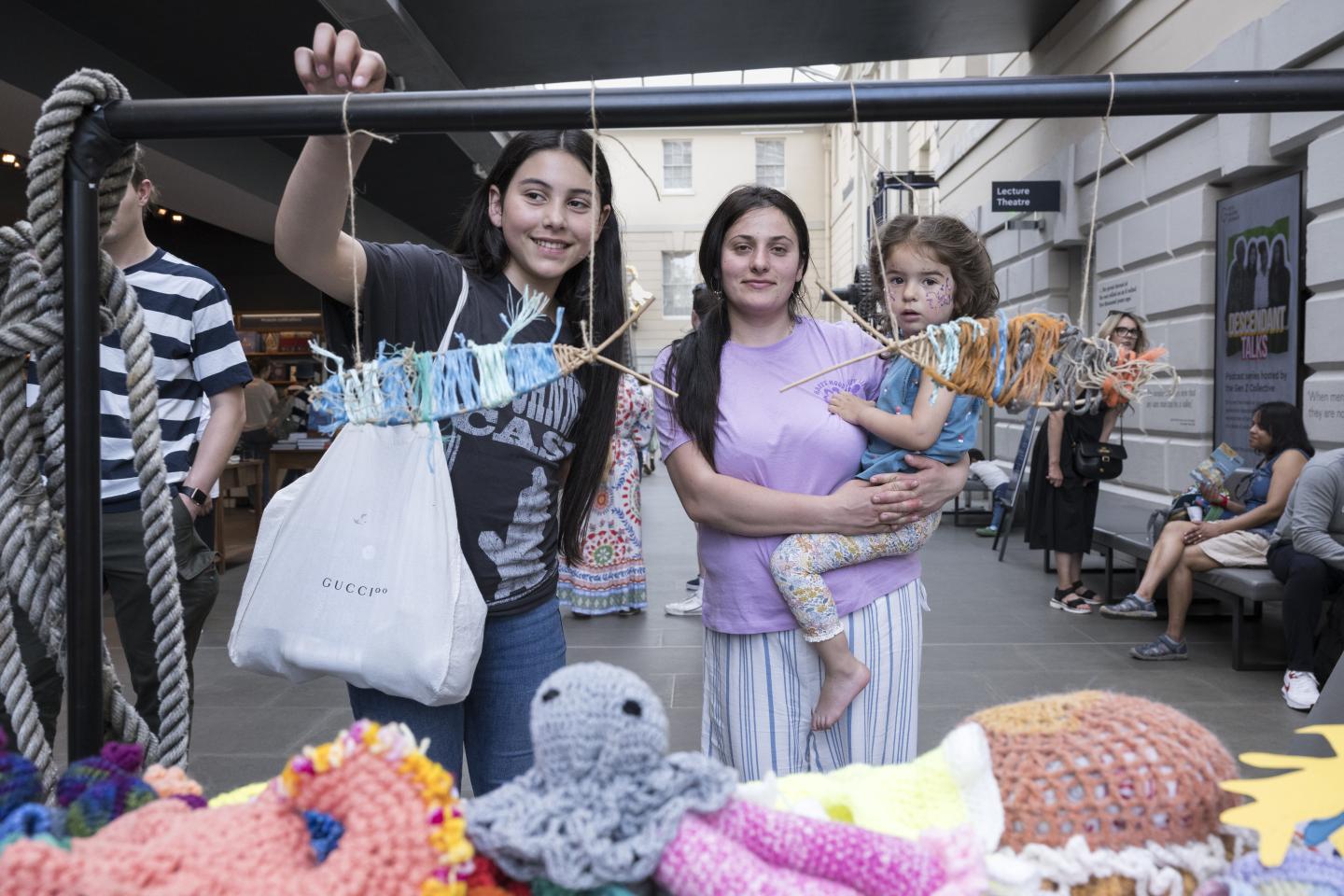 A young family take part in a craft activity at the National Maritime Museum
