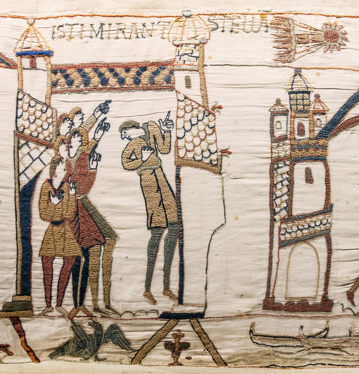 Section of the Bayeux Tapestry showing people pointing to a depiction of Halley's Comet 
