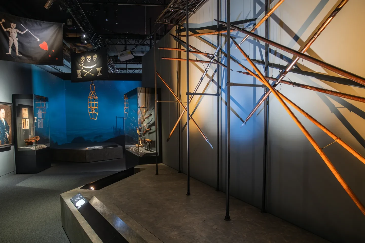 A display of weaponry including boarding pikes in the Pirates exhibition at the National Maritime Museum