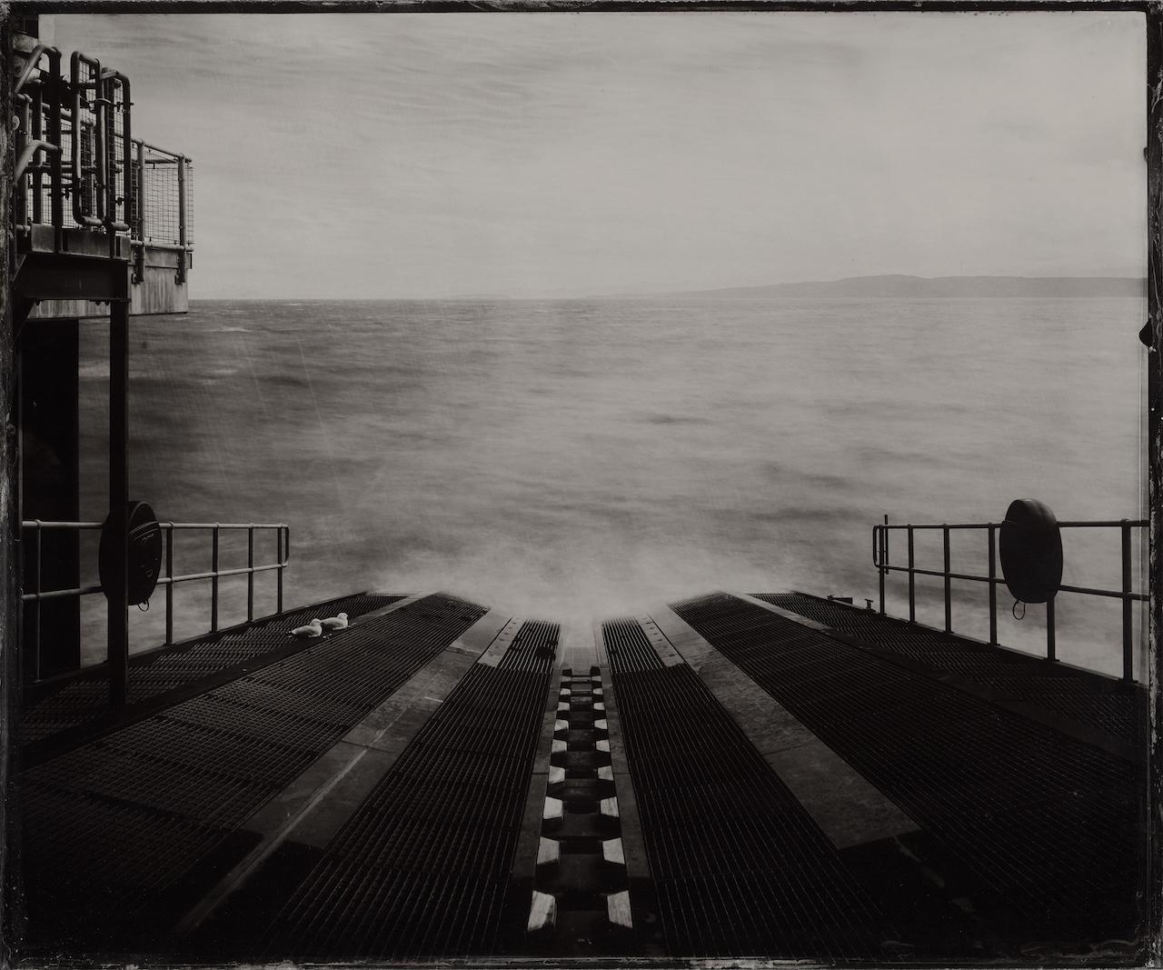 Black and white photography showing the view looking down the slipway of Moelfre RNLI Lifeboat Station