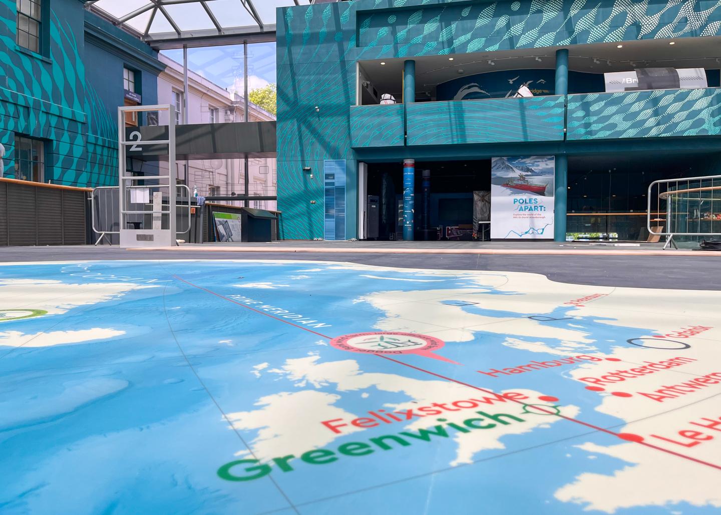 Inside the National Maritime Museum during the refurbishment of Ocean Court. A close-up view of the new Ocean Map showing the location of Greenwich is visible in the foreground