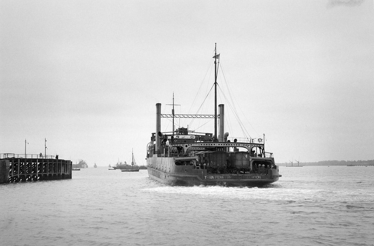 A photograph of the stern of a train ferry as it is manoeuvring into Harwich
