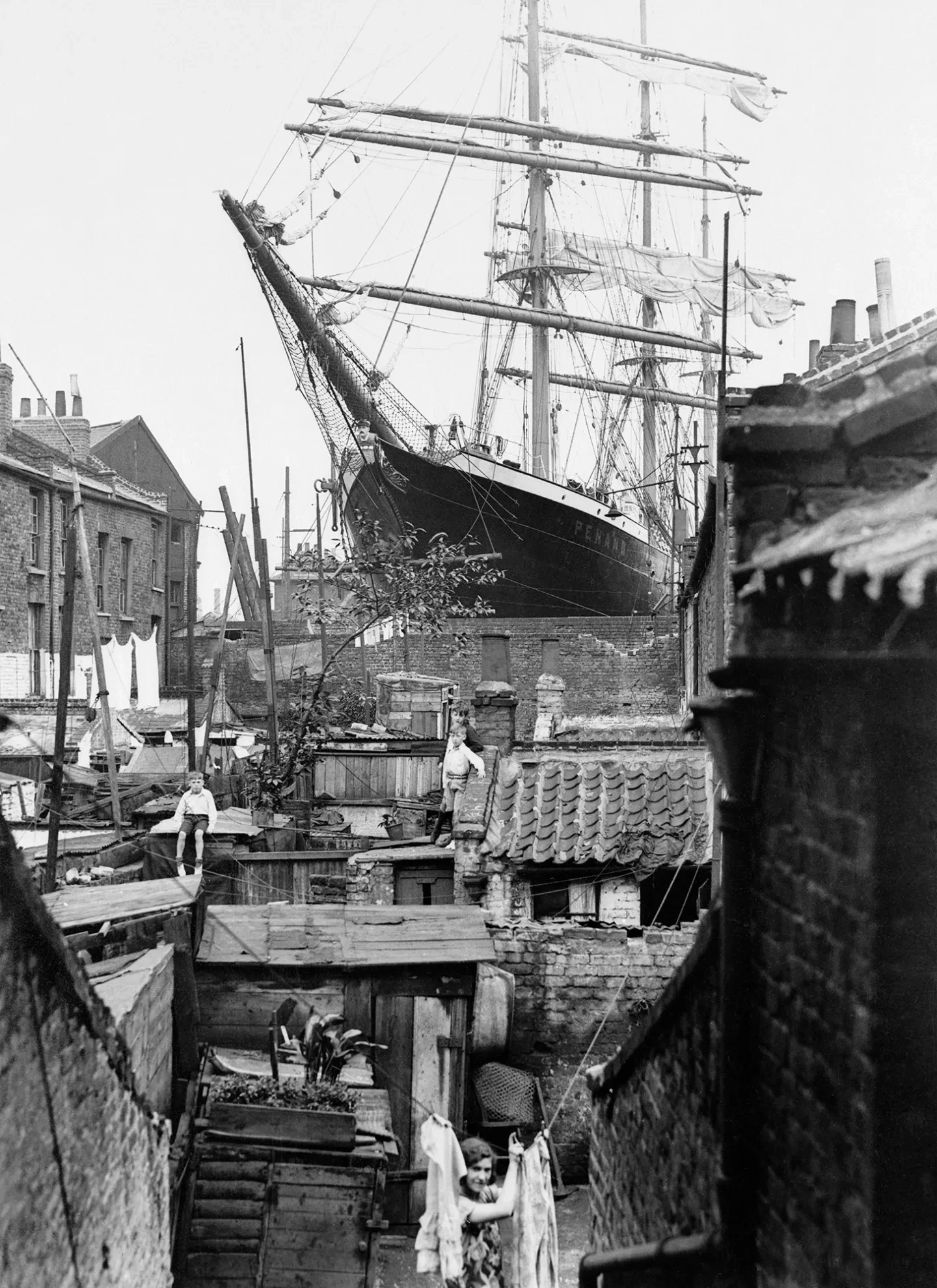Large cargo ship the Penang towers over houses and gardens in Millwall, southeast London in 1932