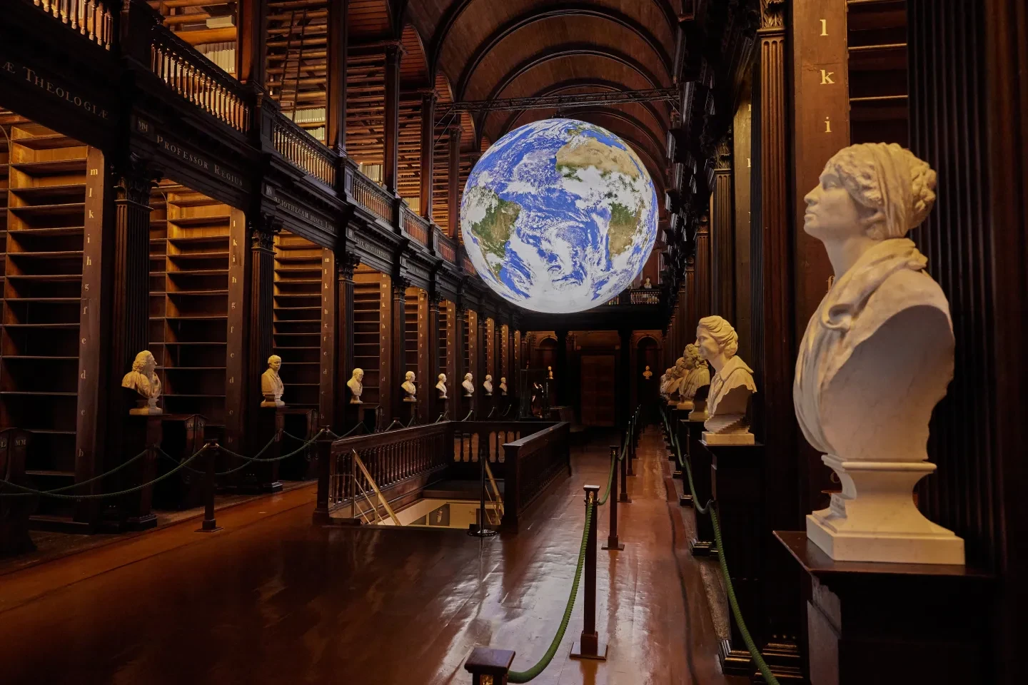 A giant inflatable Earth sculpture in the shelves of the library in Trinity College Dublin