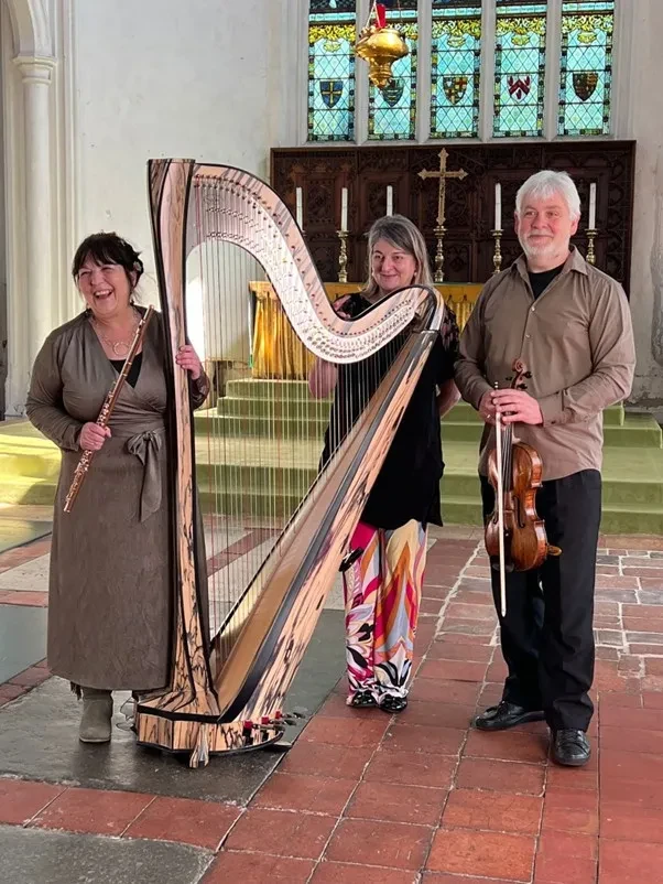 Image of London Chamber Soloists standing next to a harp