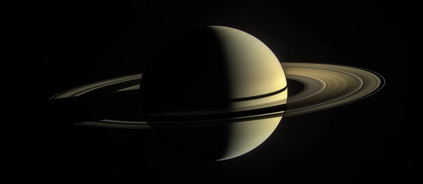 Photo of Saturn and rings illuminated from the right hand side.
