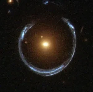 Image shows a bright point of light at the centre of the image, with an incomplete ring of light surrounding it. 