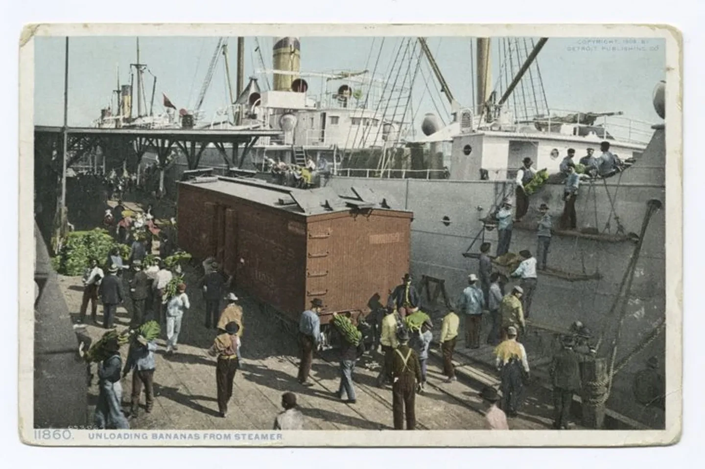 Historic image showing dockworkers unloading bananas from a ship