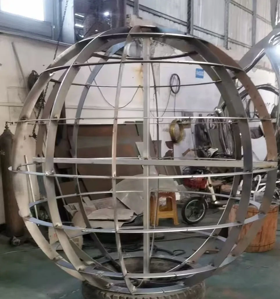 The internal structure of the Mirror Moon sculpture - rings of metal creating a strong spherical skeleton sitting on a tyre