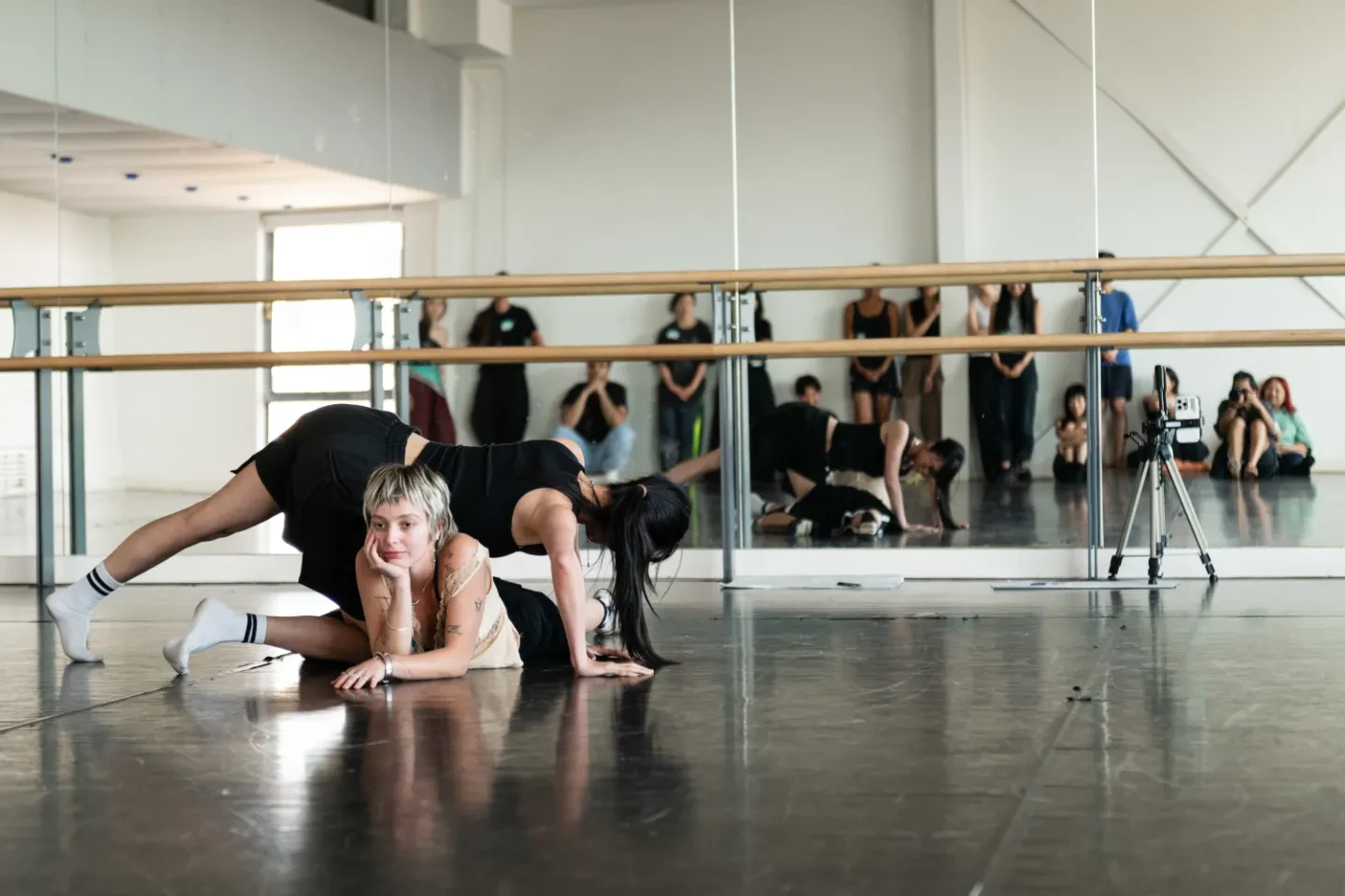 A group of dances perform in a mirrored studio