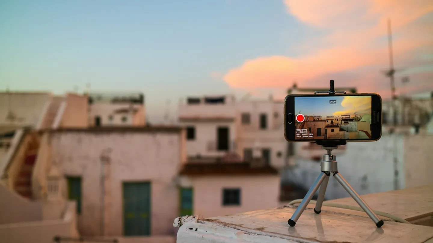 Phone on small tripod looking over houses