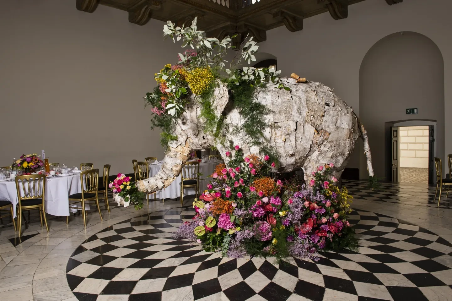 A large elephant sculpture decorated with flowers.