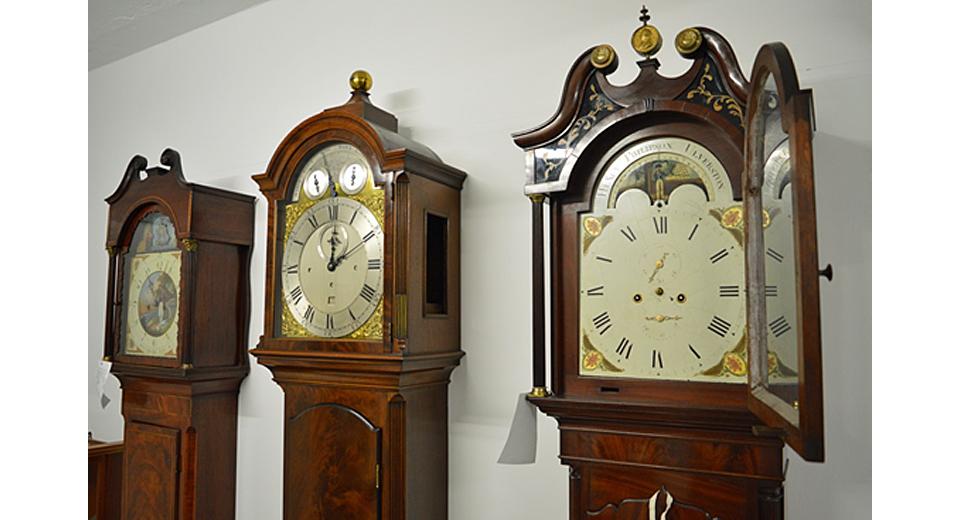 Hoods of longcase clocks with movements being installed
