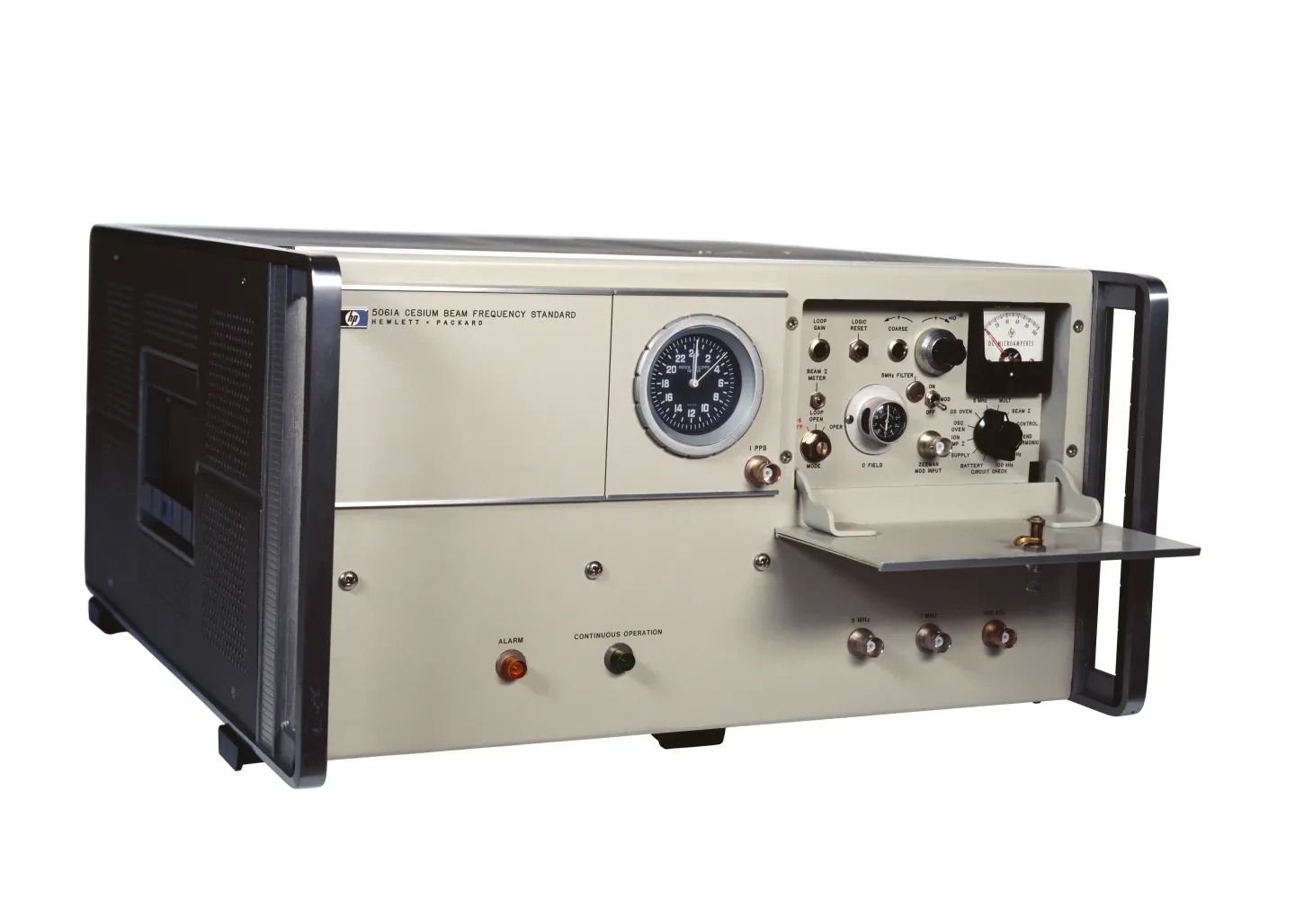 A replica of an atomic clock with black and cream casing and various dials and switches.