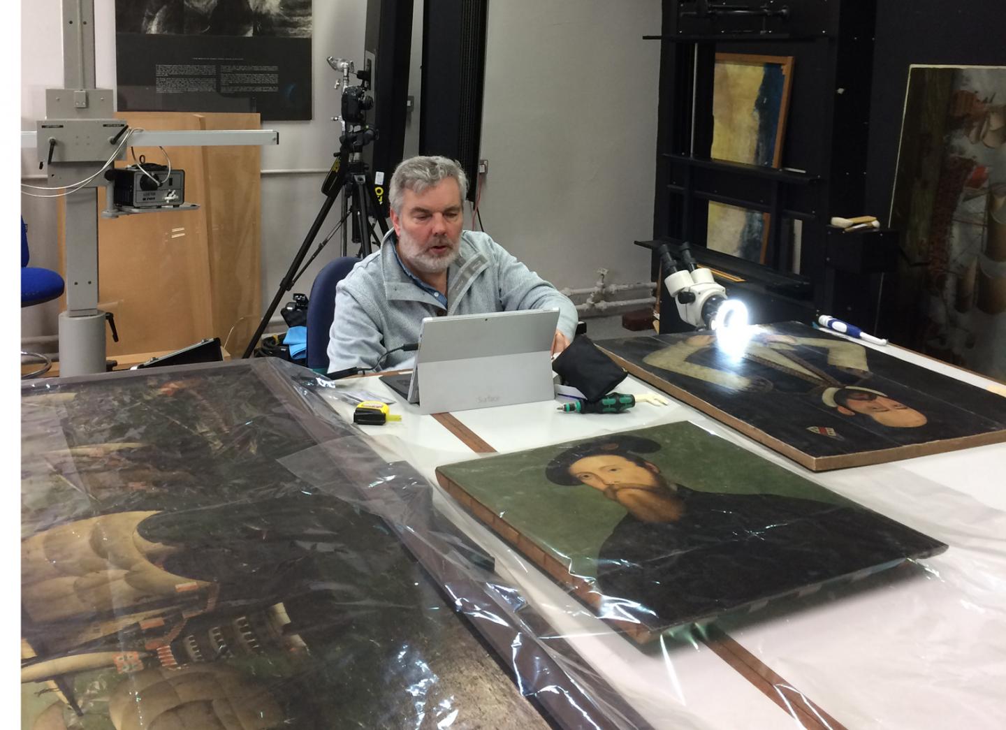 Ian Tyers, expert dendrochronologist, investigating Tudor panels in the RMG collection