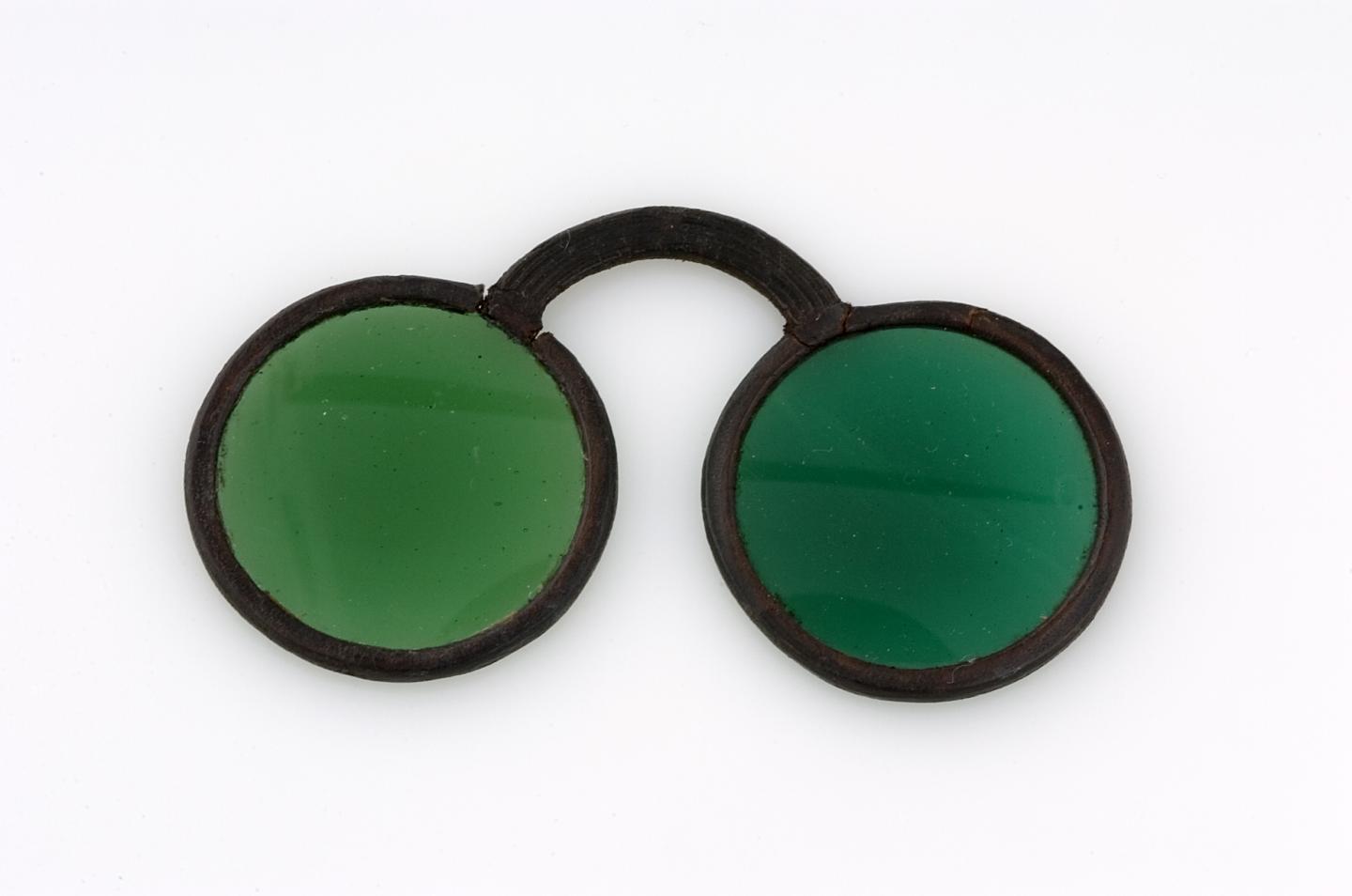 Green-tinted spectacles (The College of Optometrists)
