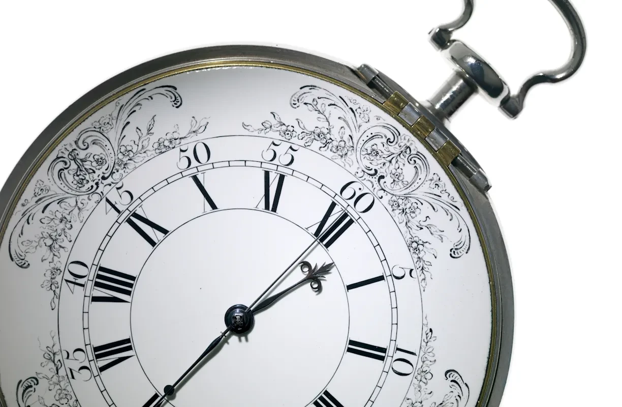 Detail of the black and white face of a Harrison timepiece.