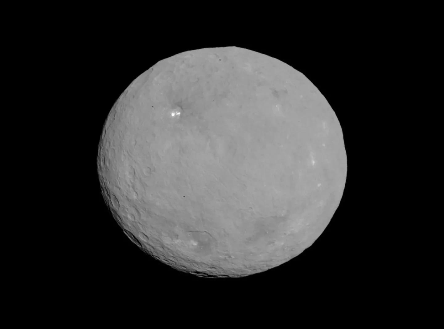 A light grey planet in a totally black sky.