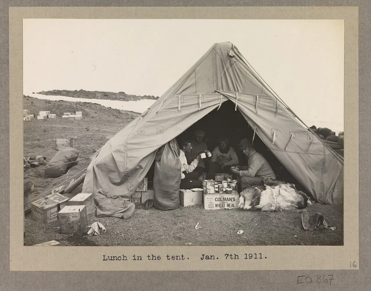 Sepia photograph of Scott's crew having lunch in a tent, 1911.