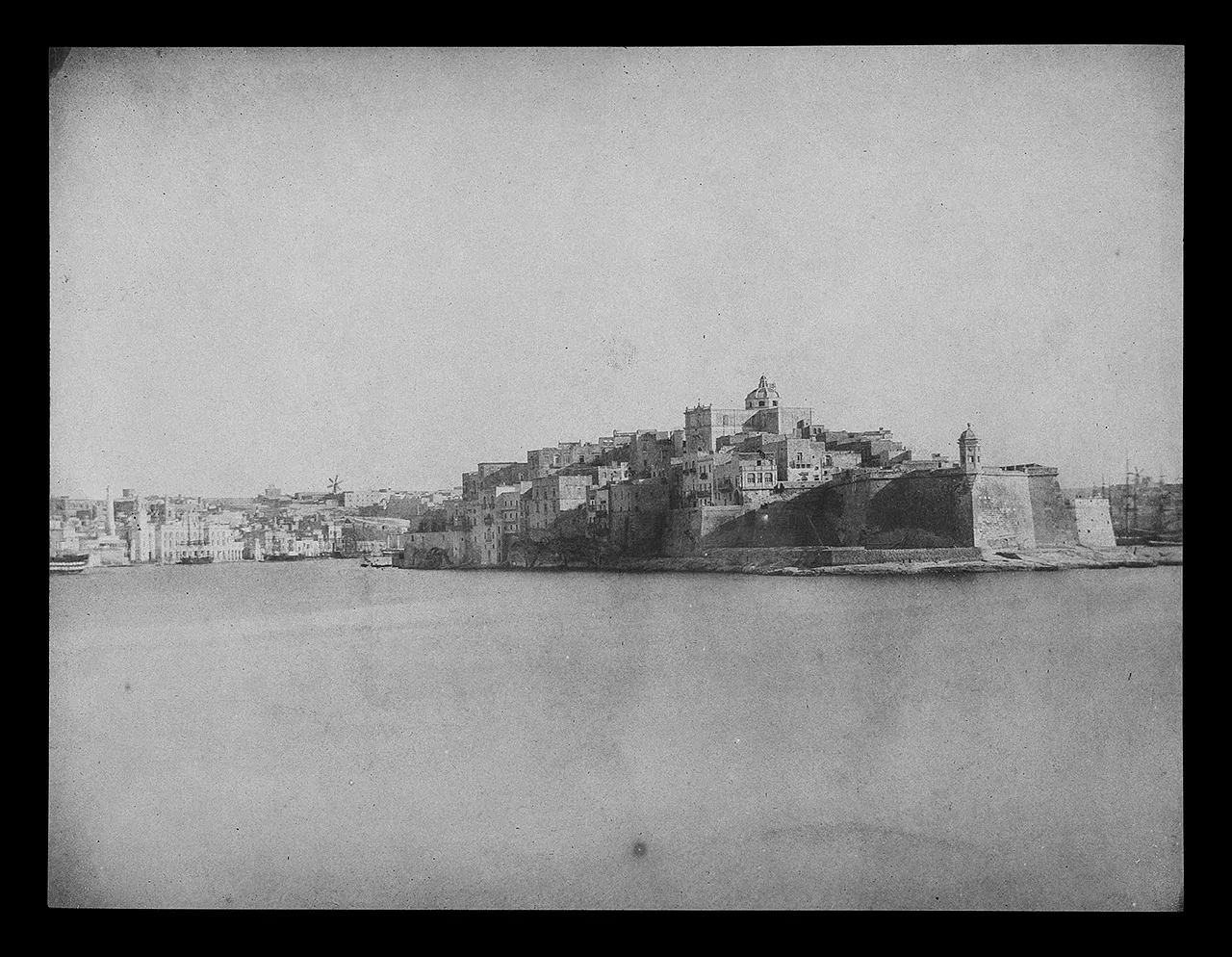 A negative image showing a coastal town.