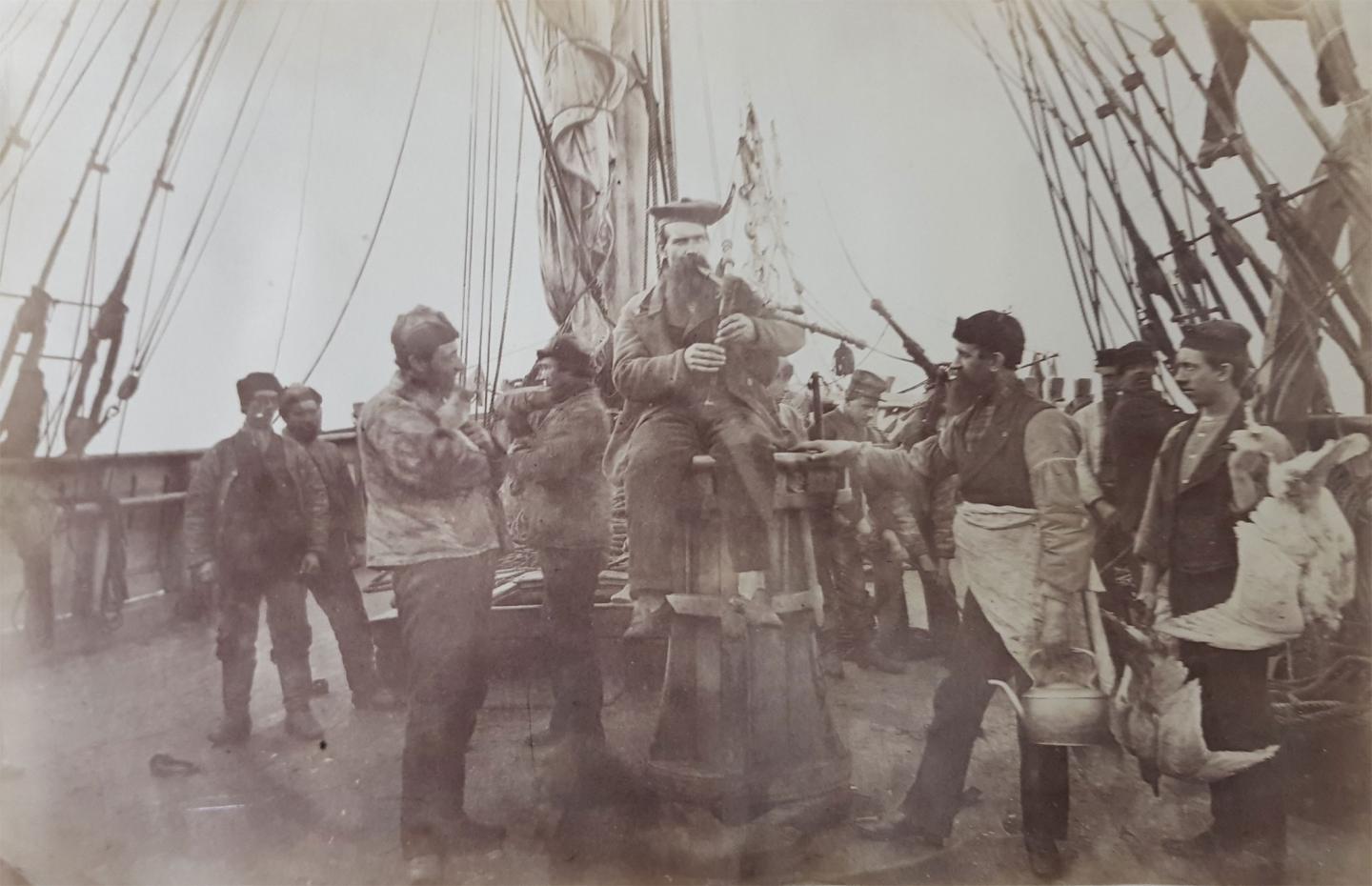 The ship’s cook playing the bagpipes for the crew.