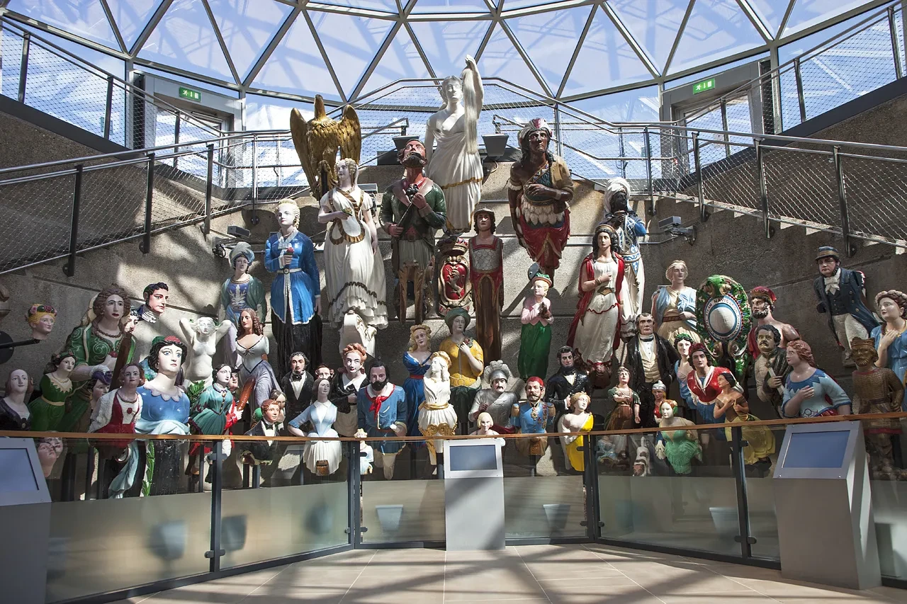 A collection of ships' figureheads on display.