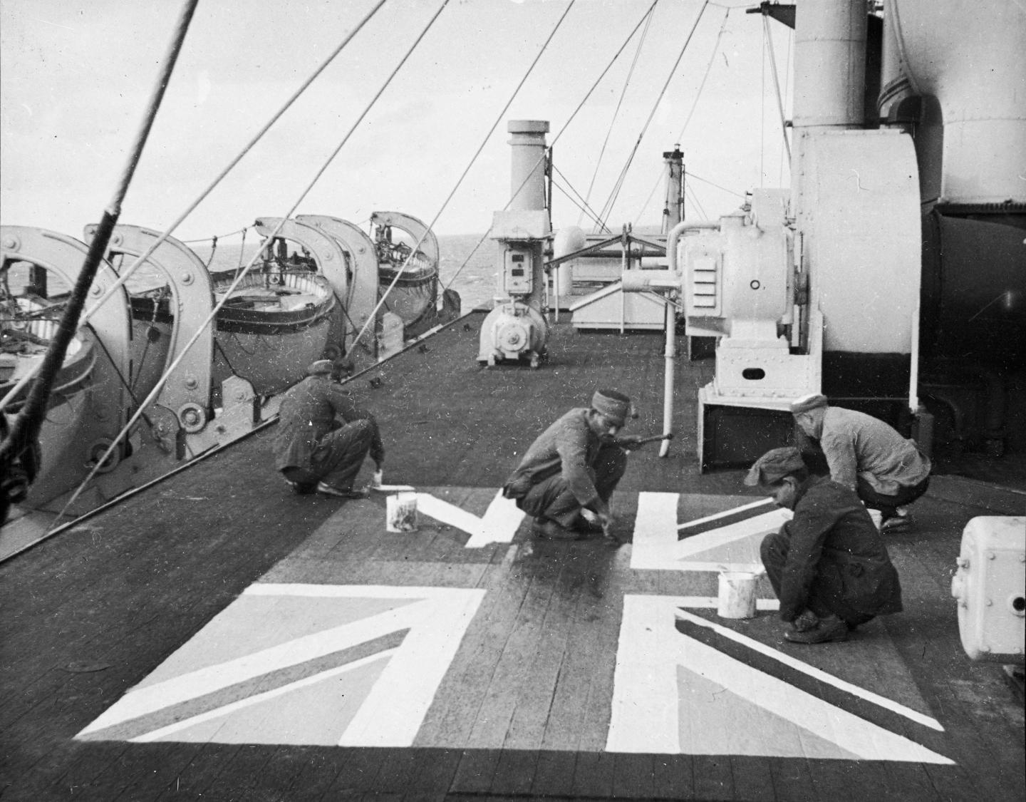 Lascars  Asian seamen painting a Union flag on the deck of the P&O liner 'Chitral'
