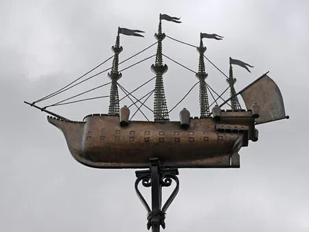 A model ship atop a weathervane.