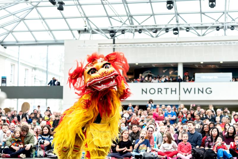 A lion dance taking place at the National Maritime Museum during Chinese New Year