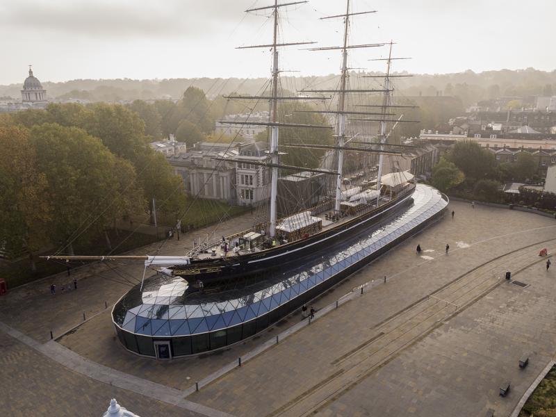A drone image of Cutty Sark with Greenwich Park in the distance