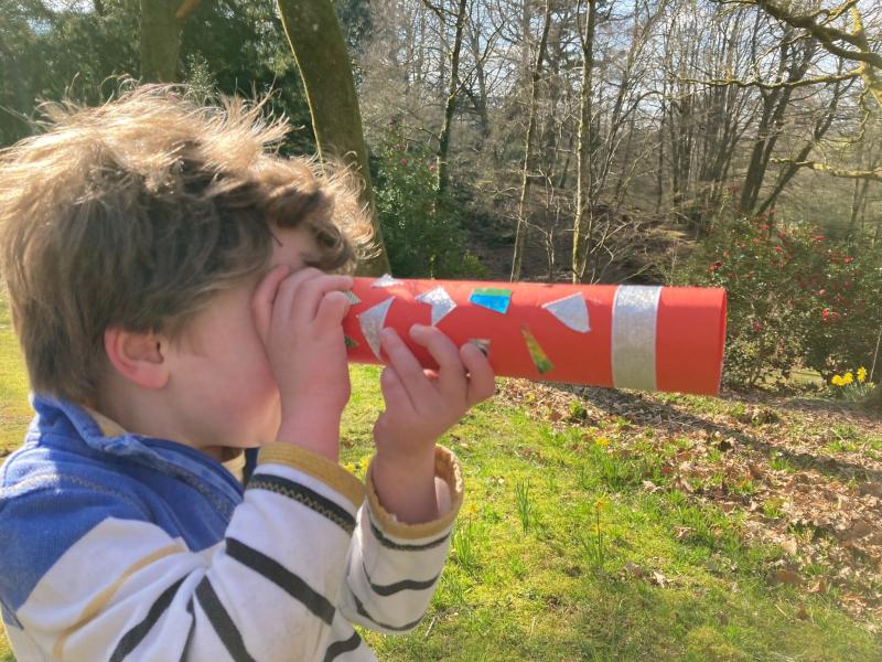 Child holding telescope