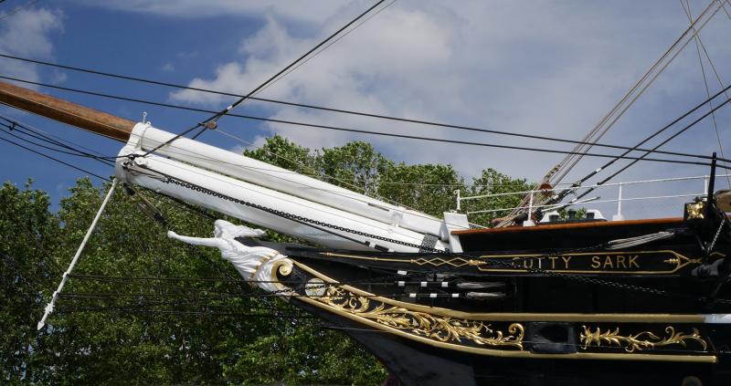 A side view of Cutty Sark's new figurehead, arm reaching out from the prow of the ship