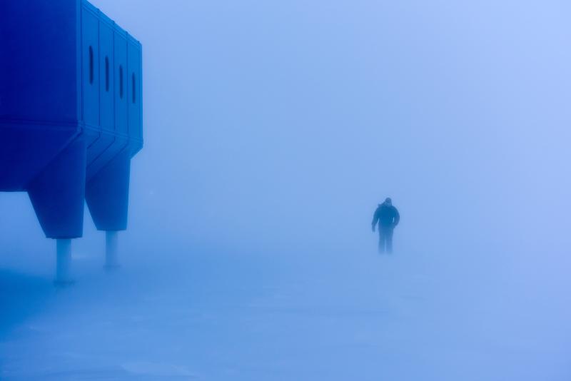 An Image from the Exposure: Lives at Sea exhibition depicting a man walking in the cold in Antarctic