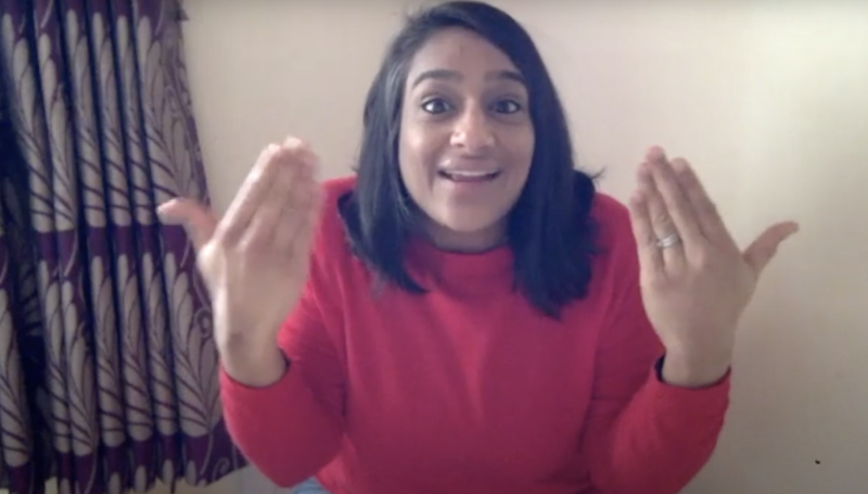 A woman performs a story using British Sign Language