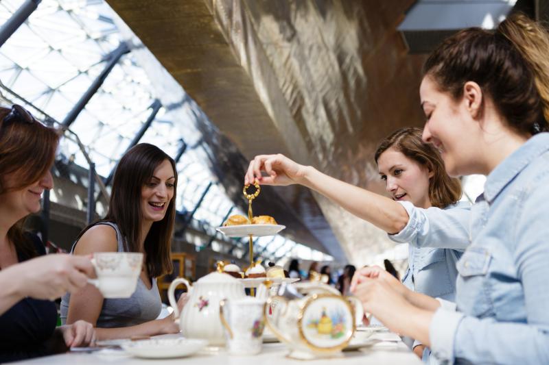 Four people having afternoon tea at Cutty Sark
