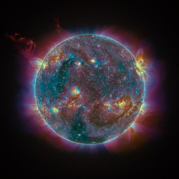 Image showing busy surface and coronal activity of the Sun, in blue and purple tone