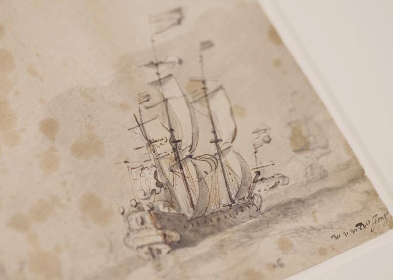 A close-up view of a drawing of a tall ship at sea. The fine lines of the masts and sails contrast with the sepia tone of the paper, which shows signs of age and staining