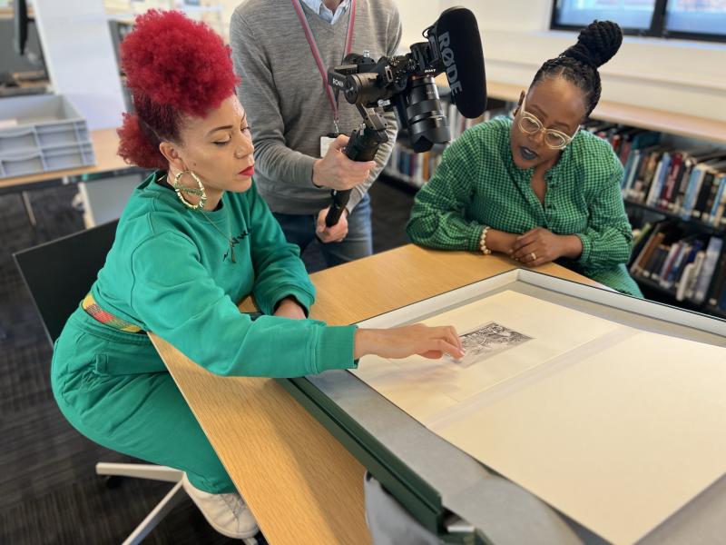 Historian Fiona Compton and Seeing Ourselves podcast host Sharon Walters examine an object in the National Maritime Museum's collections