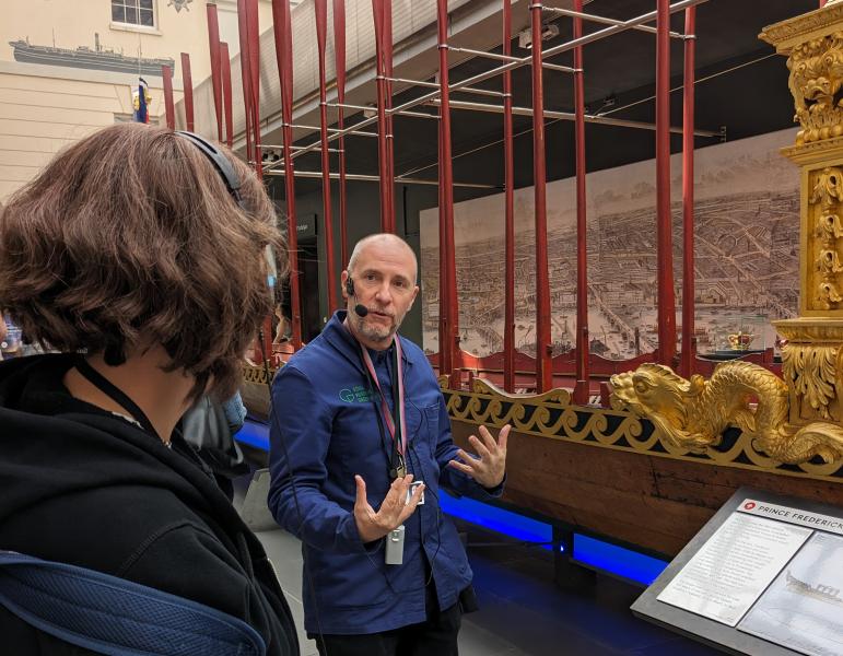 A guide takes a tour group around the Museum