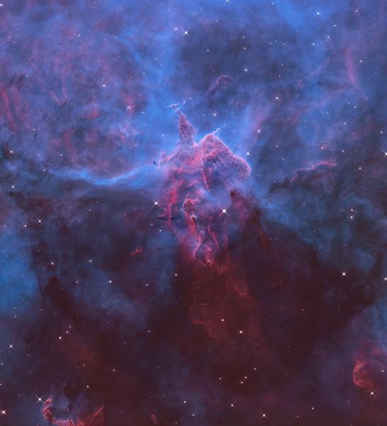Vivid blue and purple rendering of a Hubble image of a nebula, with stars smattered around the image