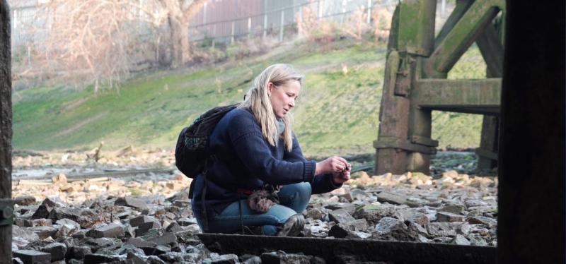 Image of woman mudlarking at Enderby Wharf