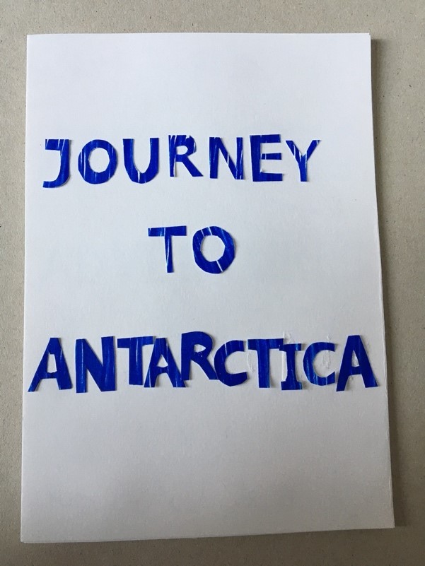 Decorate your title page An a5 page decorated with blue cut out letters saying Journey to Antarctica
